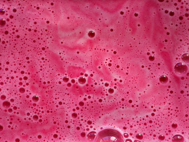 istock Texture pink foam of dissolve bath bomb in water 1458228935