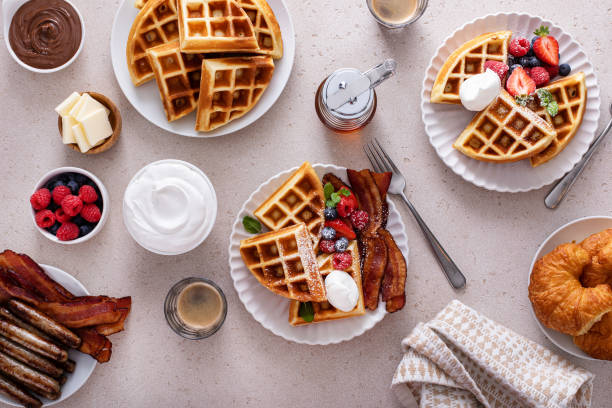 istock Breakfast table with waffles, croissants and bacon 1458229445