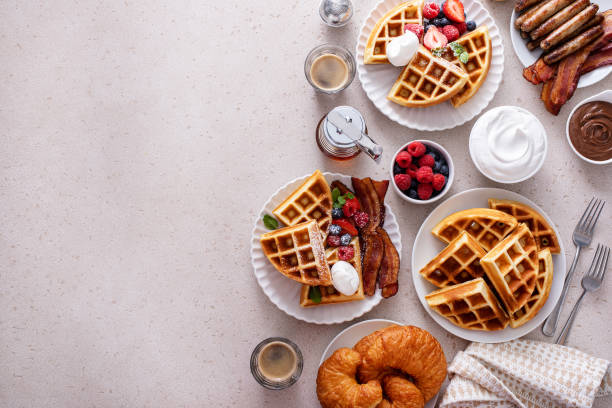 istock Breakfast table with waffles, croissants and bacon 1458229447