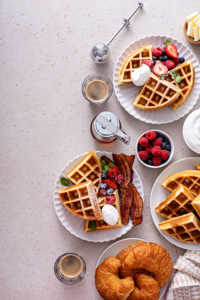 istock Breakfast table with waffles, croissants and bacon 1458229449