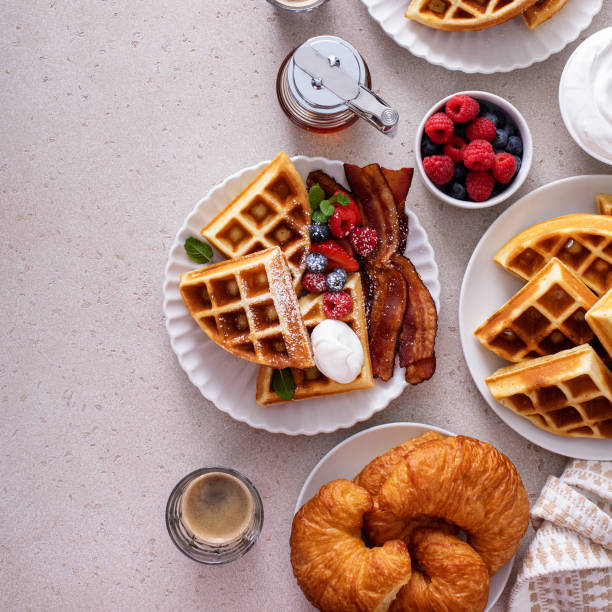 istock Breakfast table with waffles, croissants and bacon 1458229450