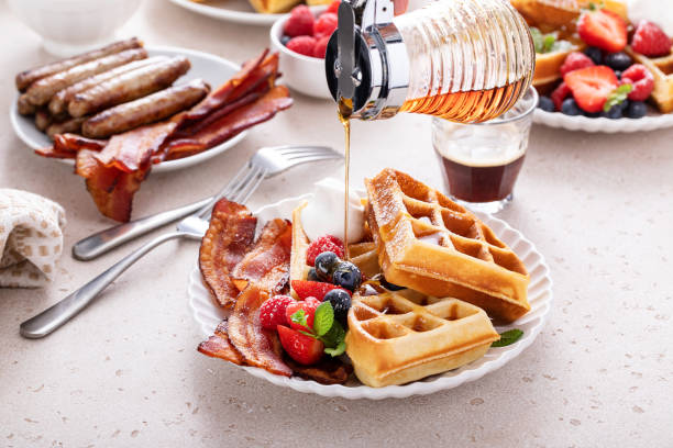 istock Breakfast table with waffles, croissants and bacon 1458229454