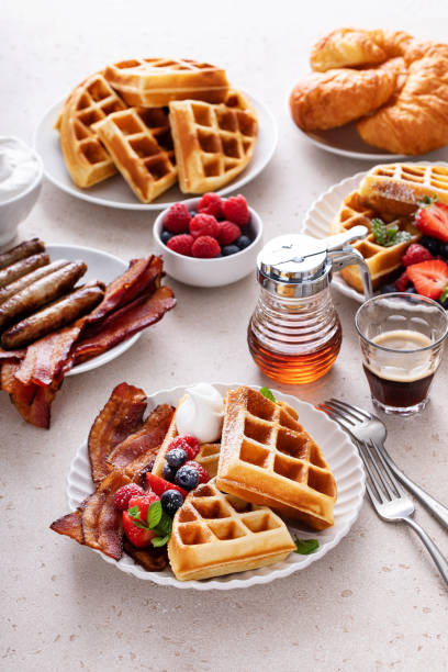 istock Breakfast table with waffles, croissants and bacon 1458229460