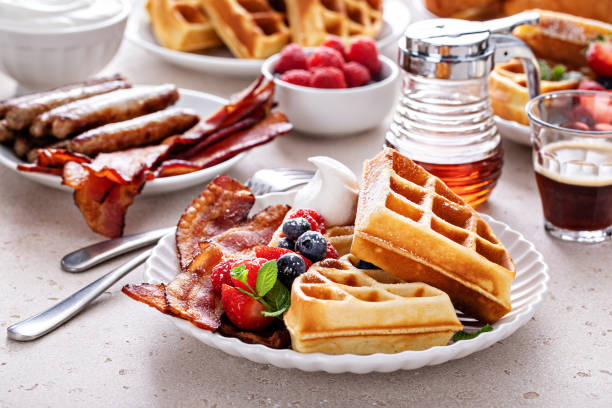 istock Breakfast table with waffles, croissants and bacon 1458229469