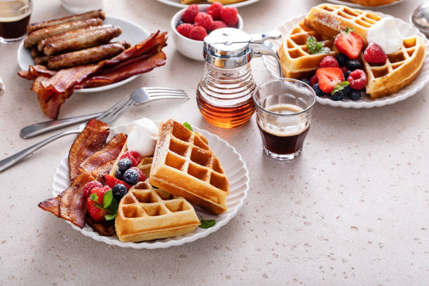 istock Breakfast table with waffles, croissants and bacon 1458229475