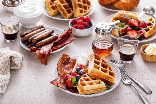 istock Breakfast table with waffles, croissants and bacon 1458229480