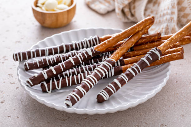 istock Chocolate covered pretzel rods homemade on a white plate 1458229629