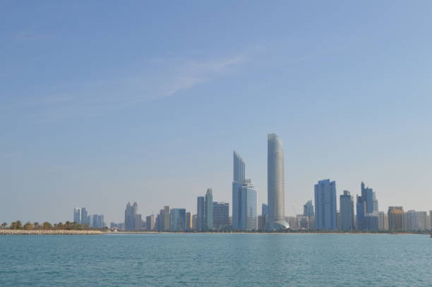 Abu Dhabi city skyline along Corniche beach taken from a boat stock photo
