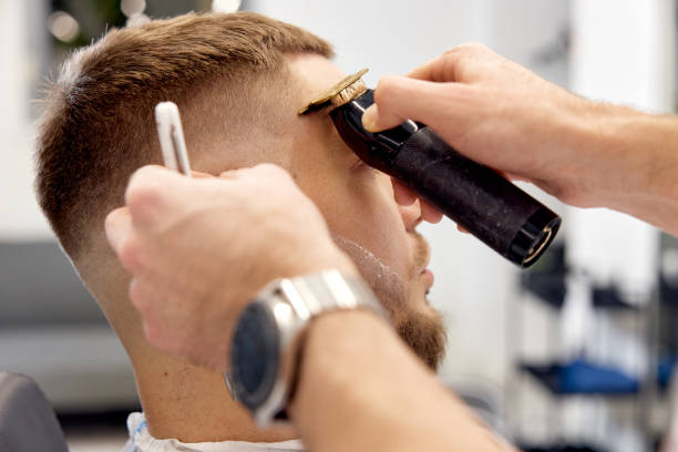istock Barber shaving bearded man with retro knife 1458234377