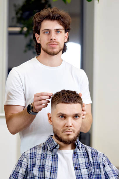 istock Barber and satisfied bearded man in barber shop 1458234537