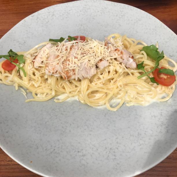 istock Spaghetti with chicken barbecue cream sauce, tomatoes 1458236594