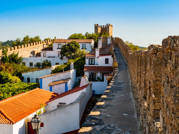 Stunning medieval walls surrounding the whitewashed houses of Obidos village, Oeste Region, Portugal stock photo