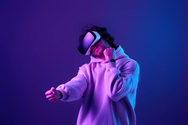 istock man in vr glasses and sweatshirt plays on blue background. 1458237194
