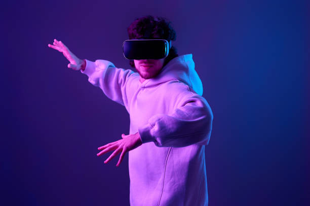 istock man in vr glasses and sweatshirt plays on blue background. 1458237202