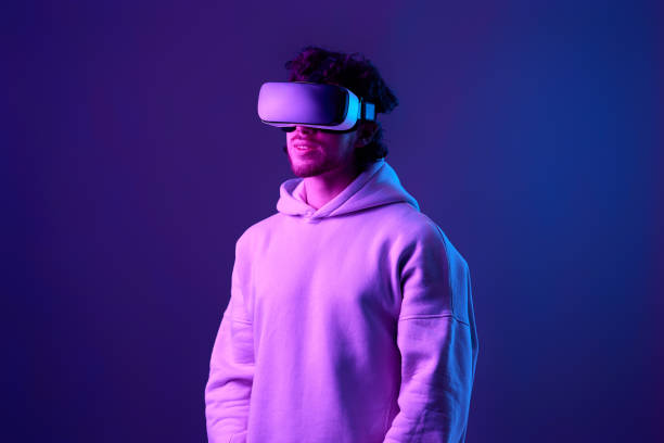 istock man in vr glasses and sweatshirt plays on blue background. 1458237209