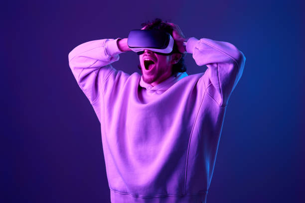istock man in vr glasses and sweatshirt plays on blue background. 1458237214