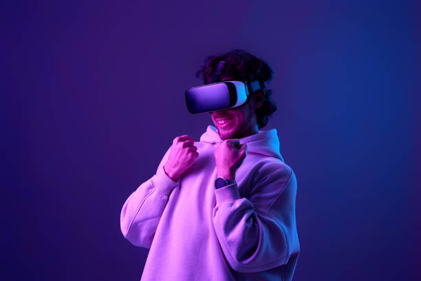 istock man in vr glasses and sweatshirt plays on blue background. 1458237227
