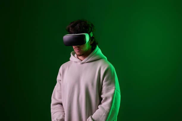 istock man in vr glasses and sweatshirt plays on blue background. 1458237232