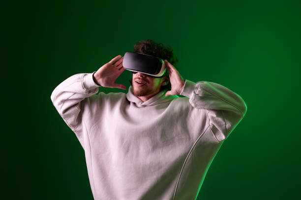 istock man in vr glasses and sweatshirt plays on blue background. 1458237237