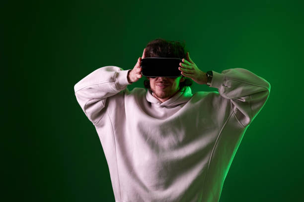 istock man in vr glasses and sweatshirt plays on blue background. 1458237239