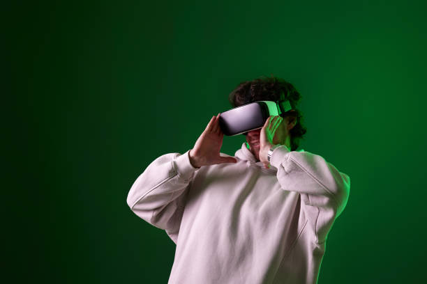 istock man in vr glasses and sweatshirt plays on blue background. 1458237240