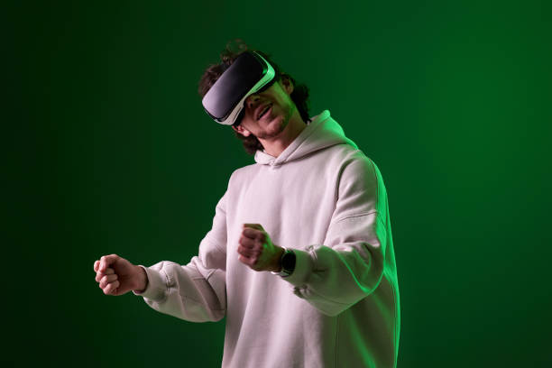 istock man in vr glasses and sweatshirt plays on blue background. 1458237252