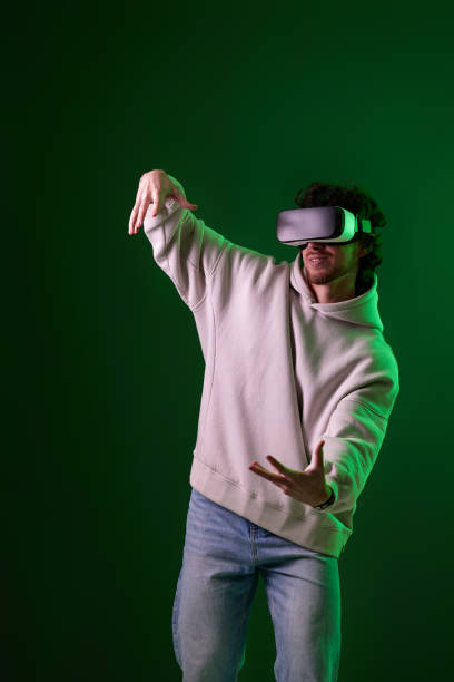 istock man in vr glasses and sweatshirt plays on blue background. 1458237265
