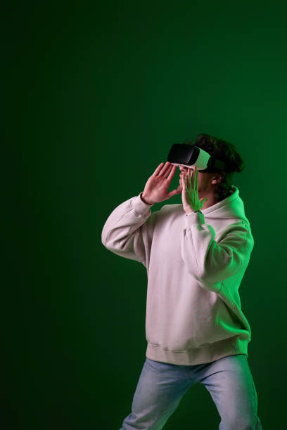 istock man in vr glasses and sweatshirt plays on blue background. 1458237294