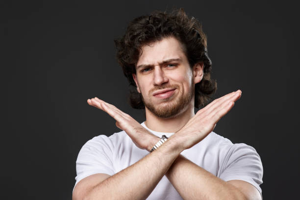 istock young upset bearded man showing stop gesture 1458237421