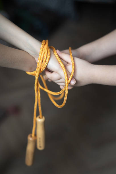 istock Children's Hands tied with a skipping rope 1458238983