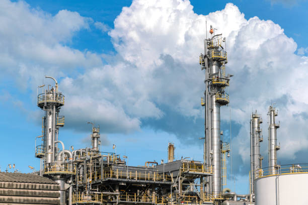 oil refinery distillation column and oil storage tank in refinery chemical petroleum and petrochemical plant operate by chemical engineer for chemical business stock photo