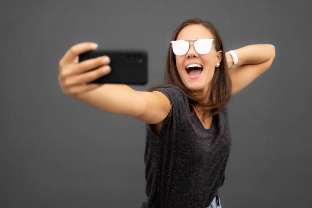 istock Excited young woman taking a selfie 1458239843