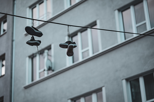 Sneakers Tied on a High-voltage Line. Housing estate. Cracov in Poland.
