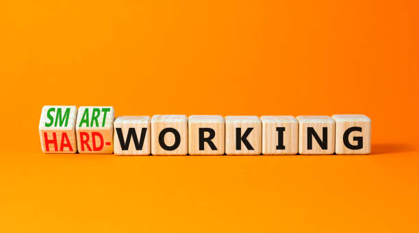 istock Smart or hard working symbol. Concept words Smart working and Hard working on wooden cubes. Beautiful orange table orange background. Business smart or hard working concept. Copy space. 1458244777