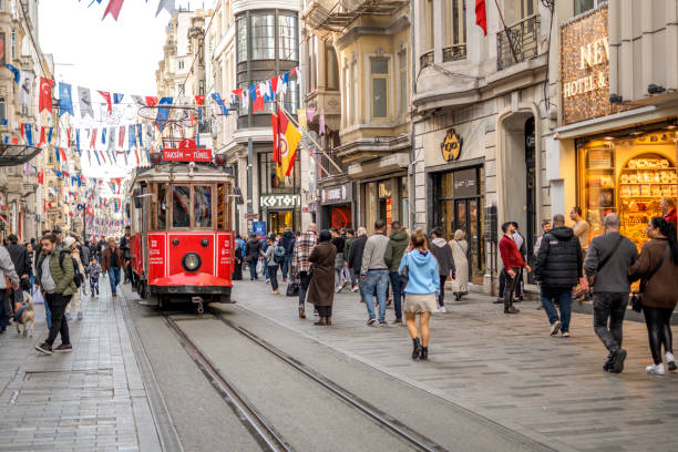 People walking and nostalgic tramway on Istiklal Avenue in Istanbul, Turkey stock photo