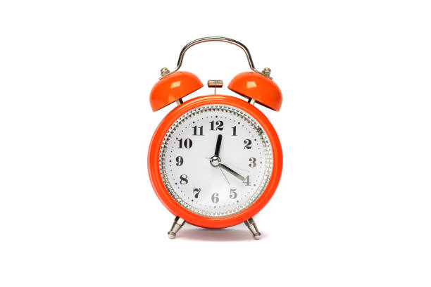 istock Red old style alarm clock isolated on white. 1458249886