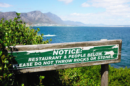 Don't throw stones: they might hurt people below, says sign in Hermanus.