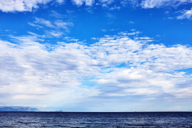 istock Intricate cloud formations over a beautiful ocean just before dusk 1458250919