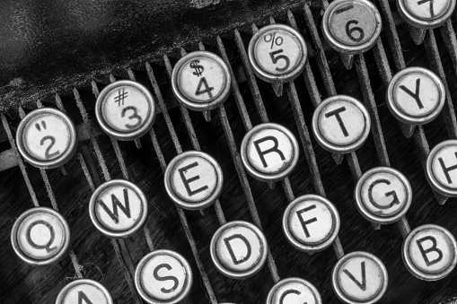 Antique typewriter showing traditional QWERTY keys. Before text messaging, people used typewriters to communicate by writing letters.