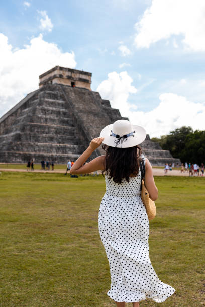 istock Tourist visiting Chichen Itza pyramid in Mexico 1458257320