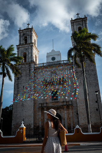 Woman looking at church in Valladolid town, Mexico