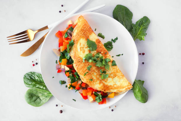 istock Healthy vegetable omelette, top down view table scene over white marble 1458259795
