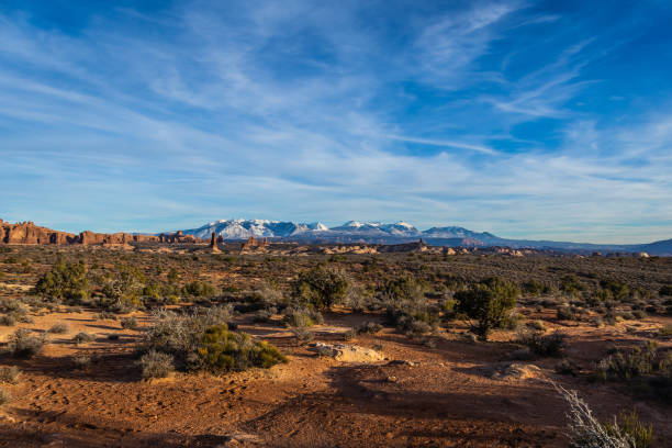 istock Rock formations with distant snow-covered mountains in the distance 1458261509