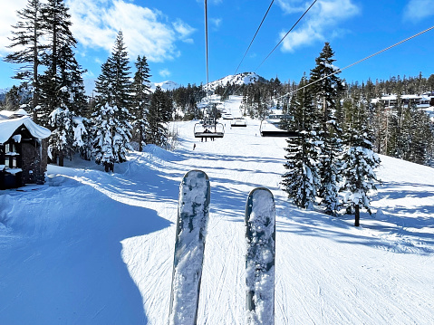 Couple skiing on a sunny powder day