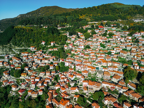 Aerial view of town settled on mountain slopes. Traditional architecture and culture of living. Photo made with drone