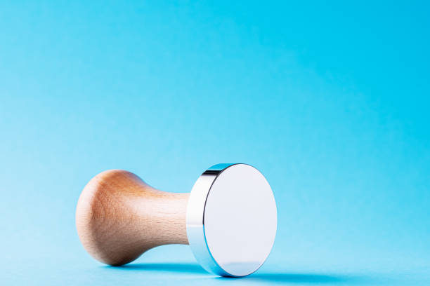 istock Coffee tamper with wooden handle on a blue background 1458265468
