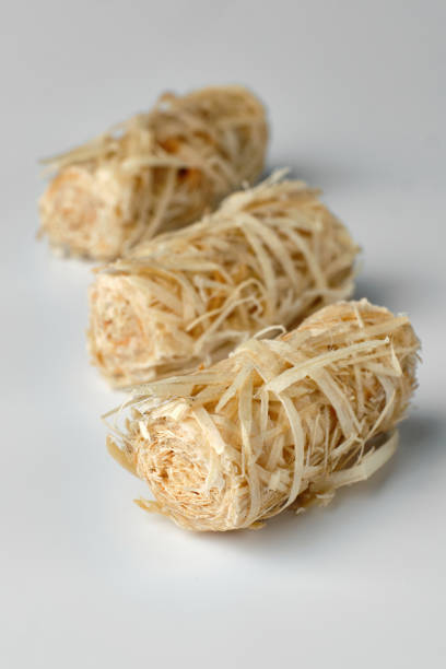 istock Three wooden kindling rolls isolated on white 1458266354