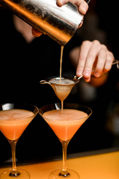 istock selective focus on sieve through which cocktail is poured from shaker into martini glass 1458268327