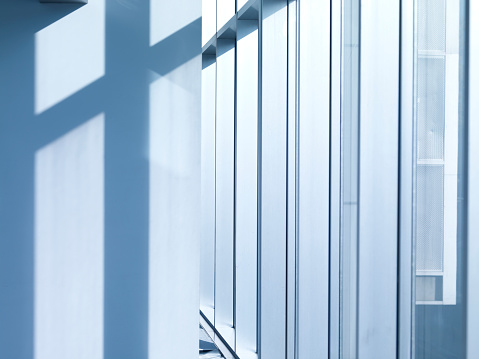 Corridor in office building with big windows passing daylight