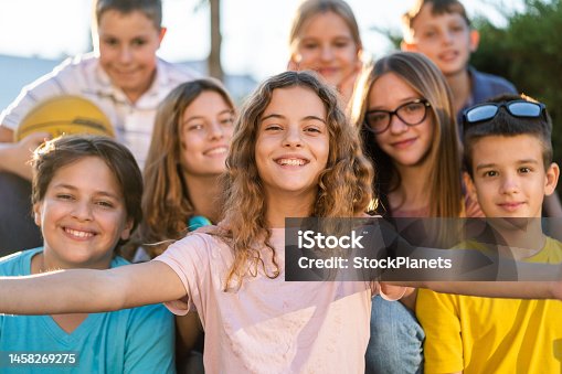 istock Group of happy teenagers taking a selfie on city street 1458269275